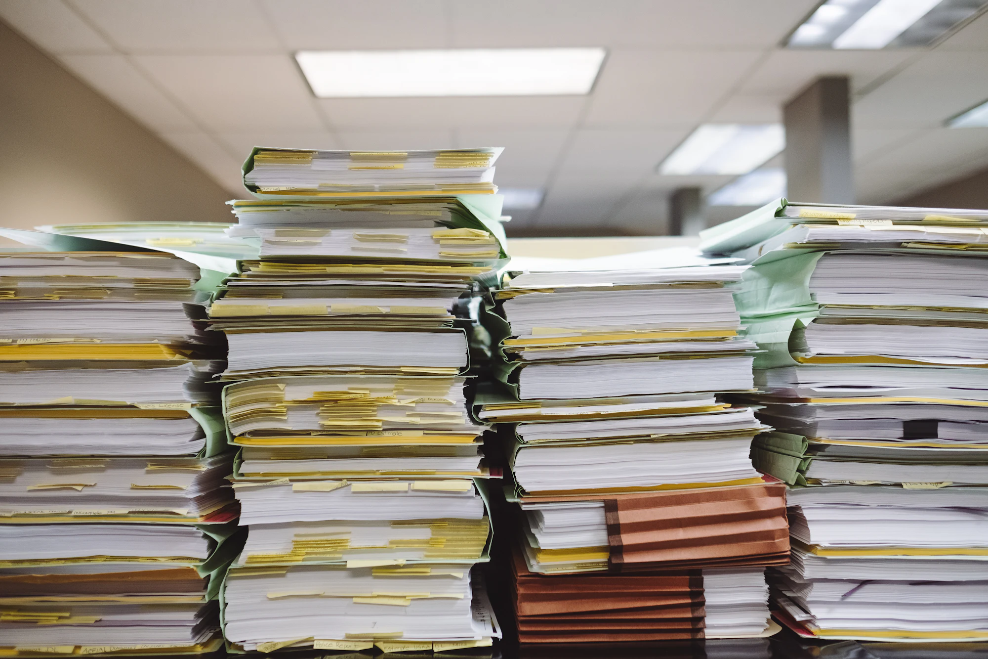 Stacks of folders and paperwork in an office